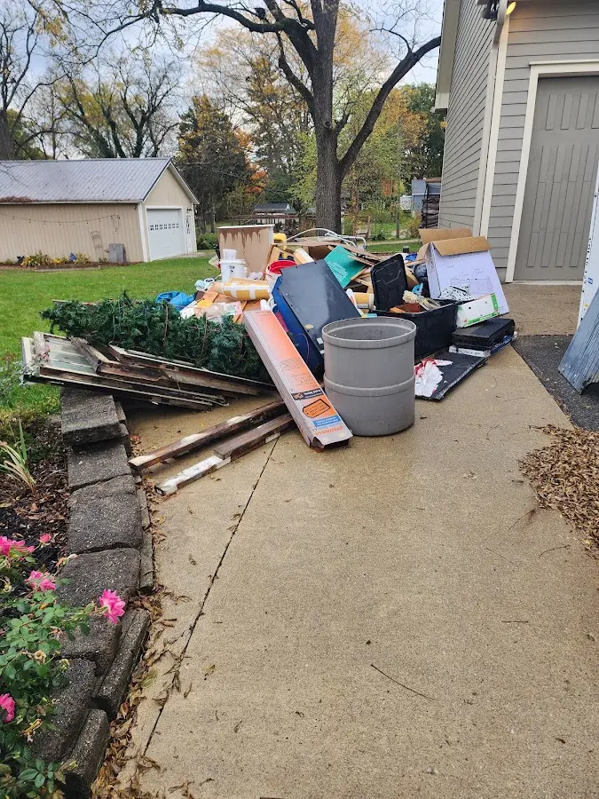 Dumpster being loaded with debris for Estate Cleanout Dumpster Rental in Colusa